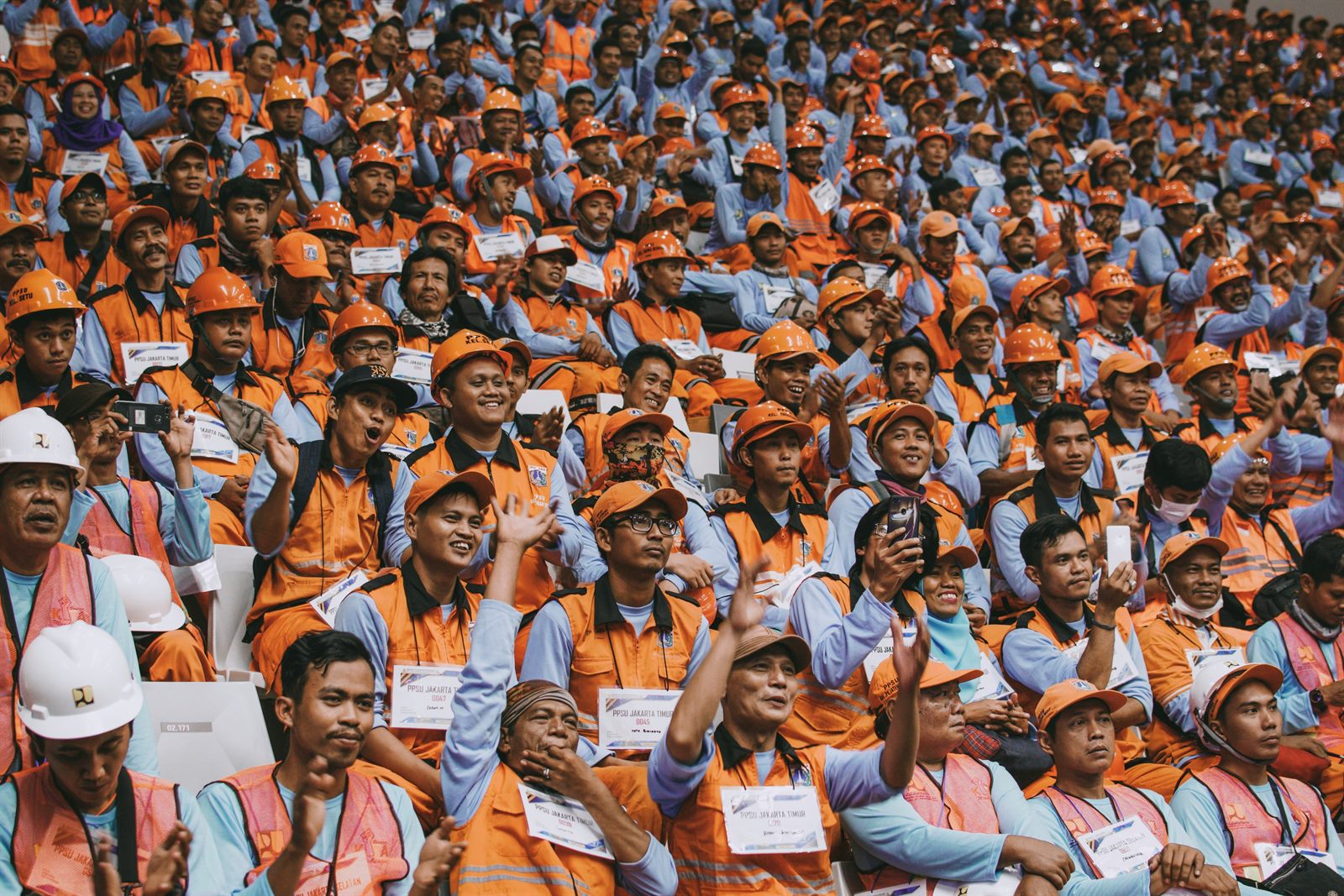 Workers holding union signs outside a large corporate building during a labor action