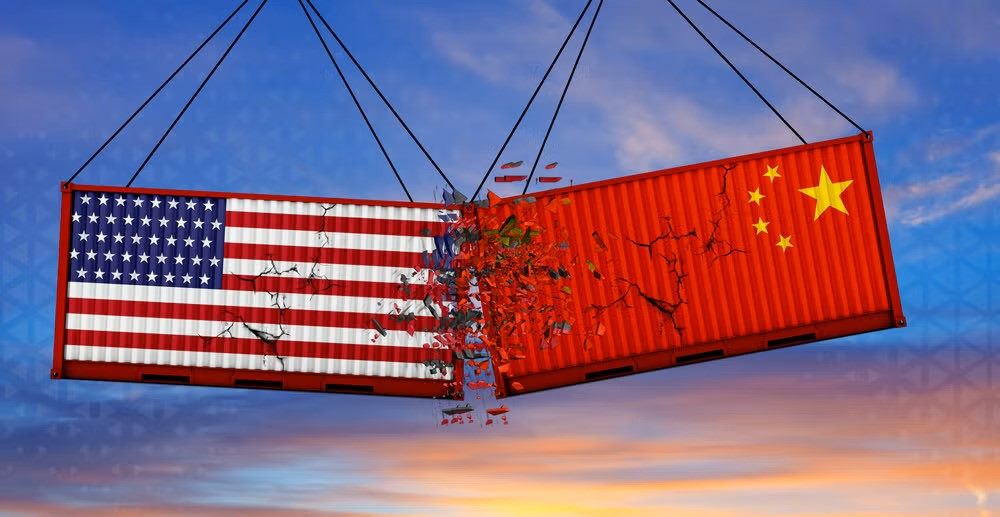 American and Chinese flags on flagpoles facing each other under an overcast sky