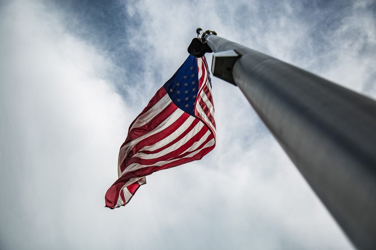 The United States Capitol dome under a divided sky, half in light and half in shadow