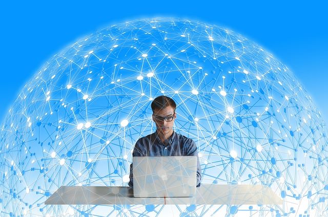 Neuroscientist analysing brain activity data on multiple computer screens