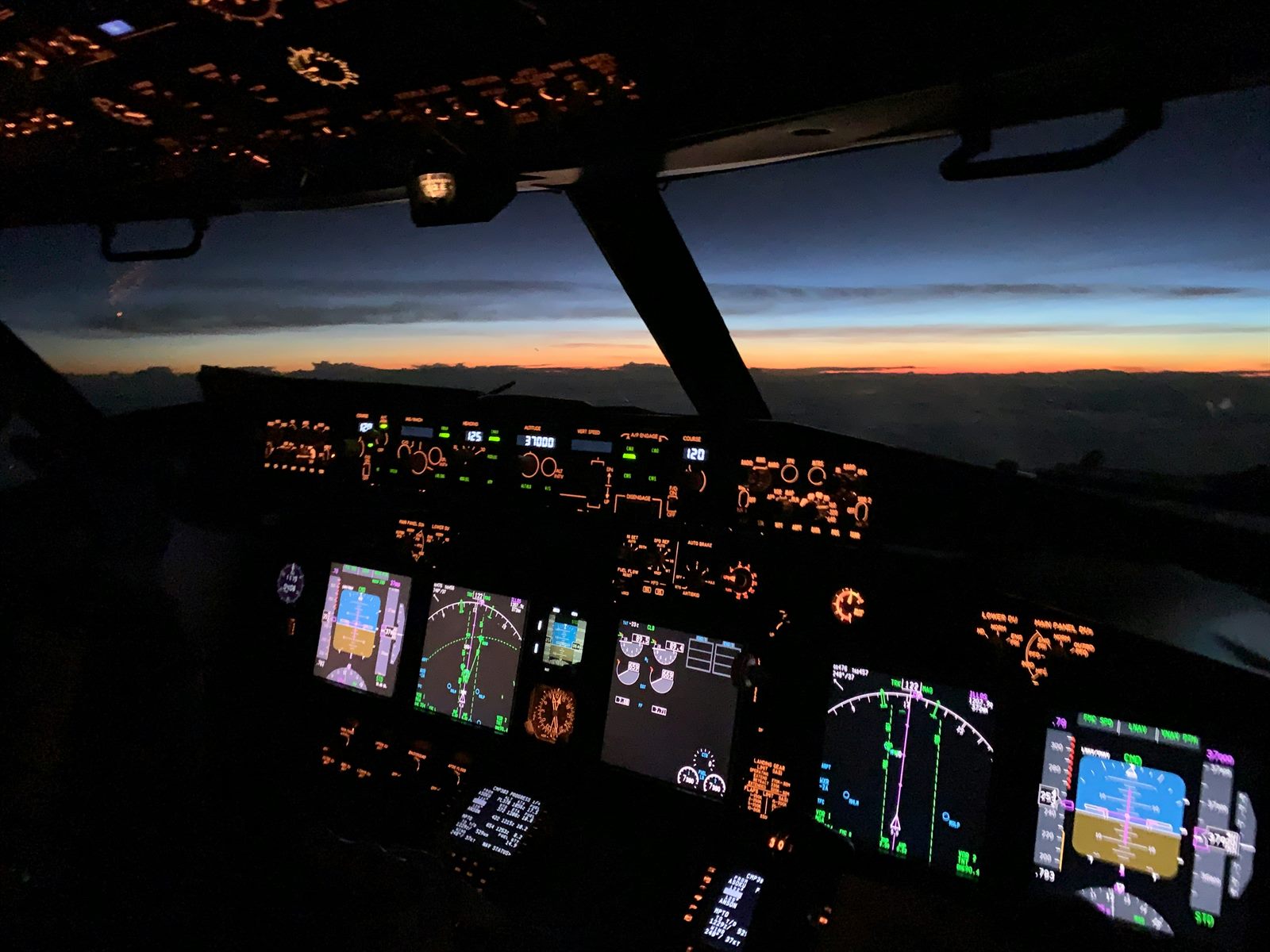 Air traffic control tower at dusk with autonomous drone aircraft in background