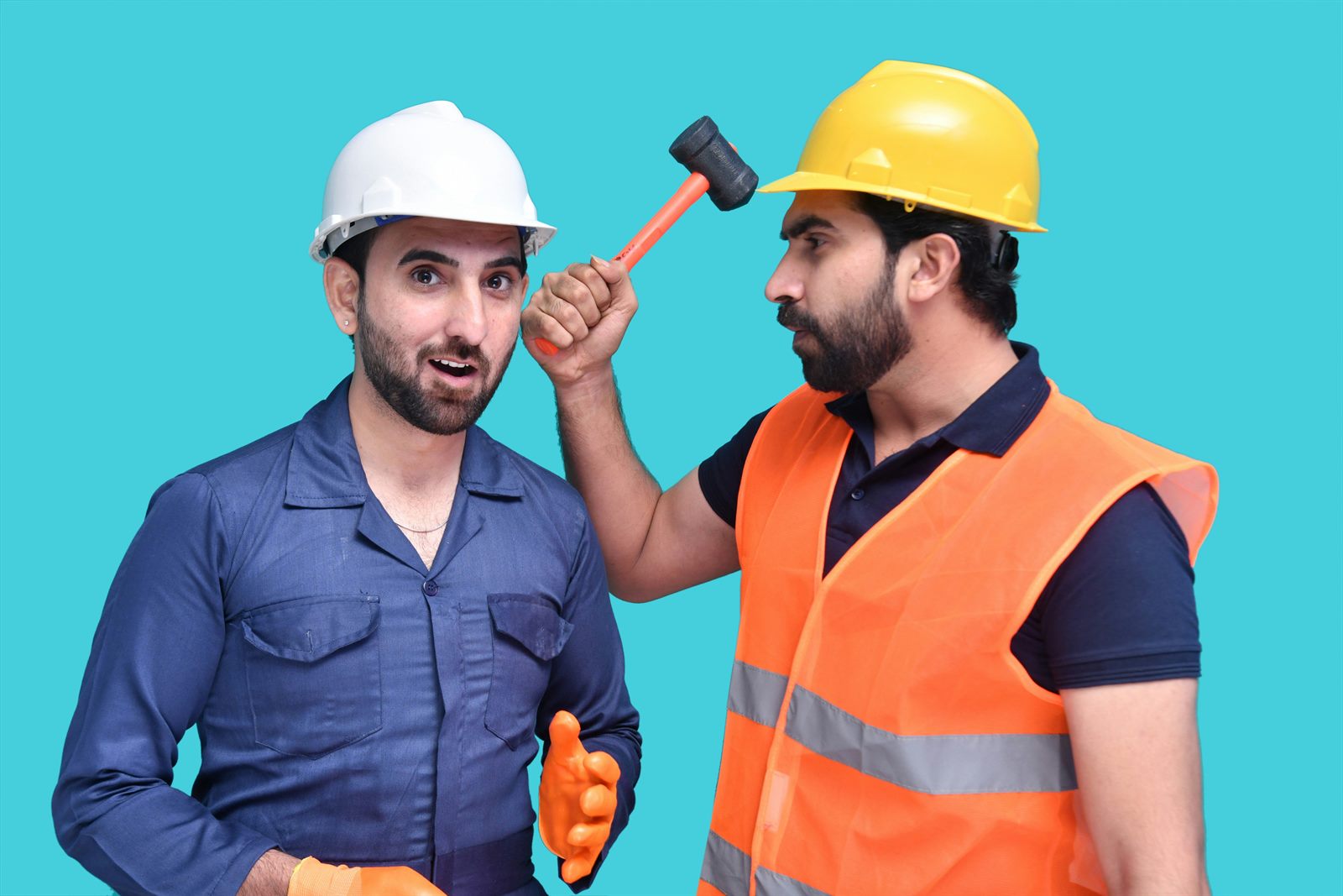 Young apprentice and experienced tradesperson working together on a construction site