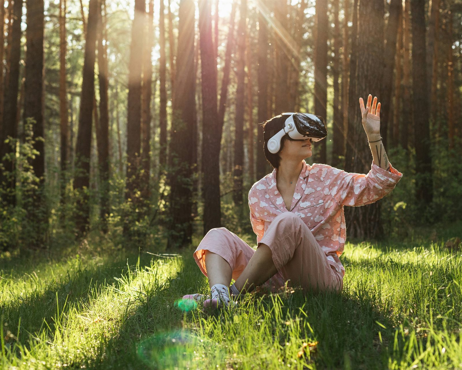 Person wearing a VR headset in a living room, appearing to look out over a mountain vista