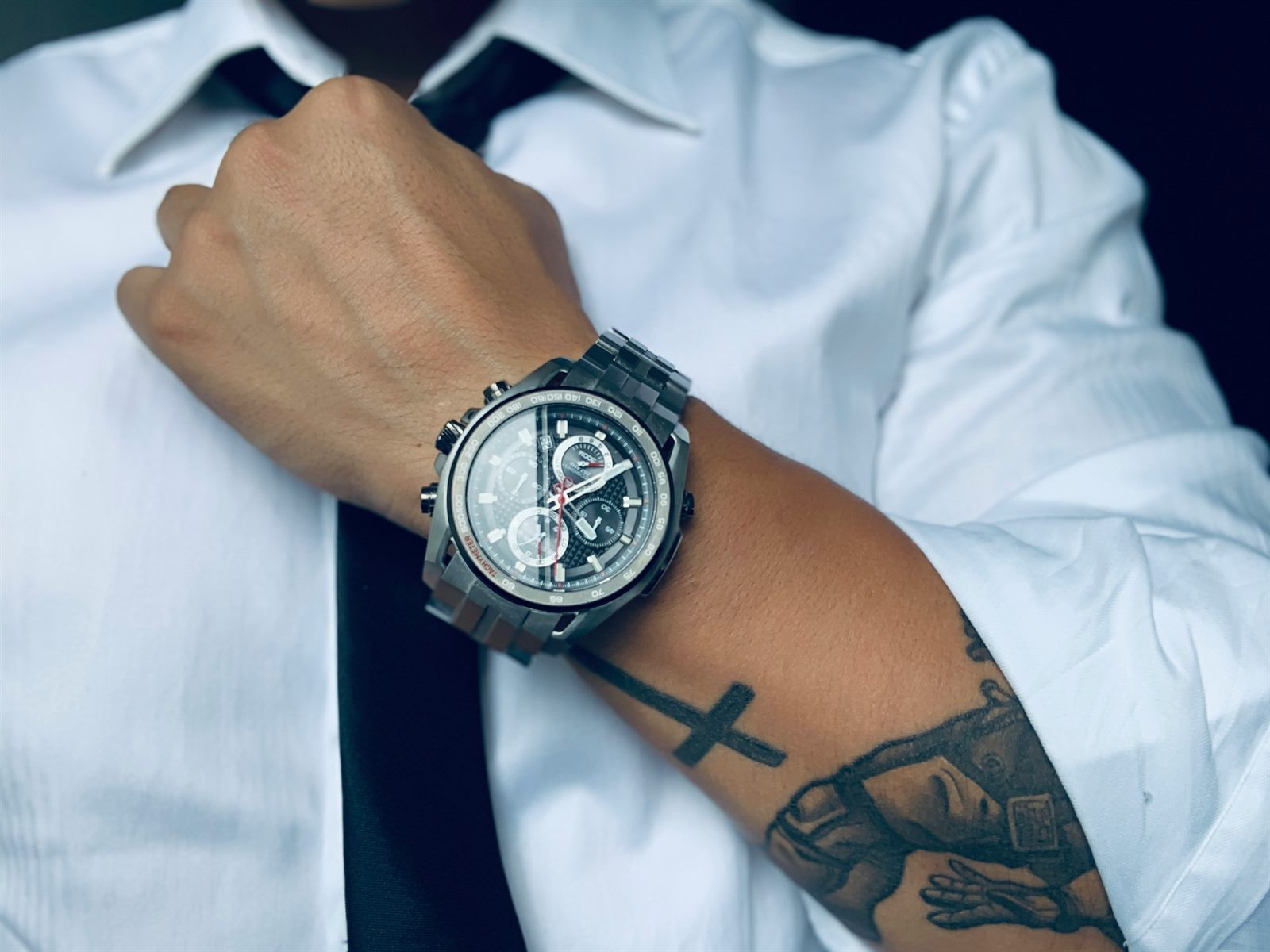 Diverse team in a modern workplace with visible tattoos and professional attire
