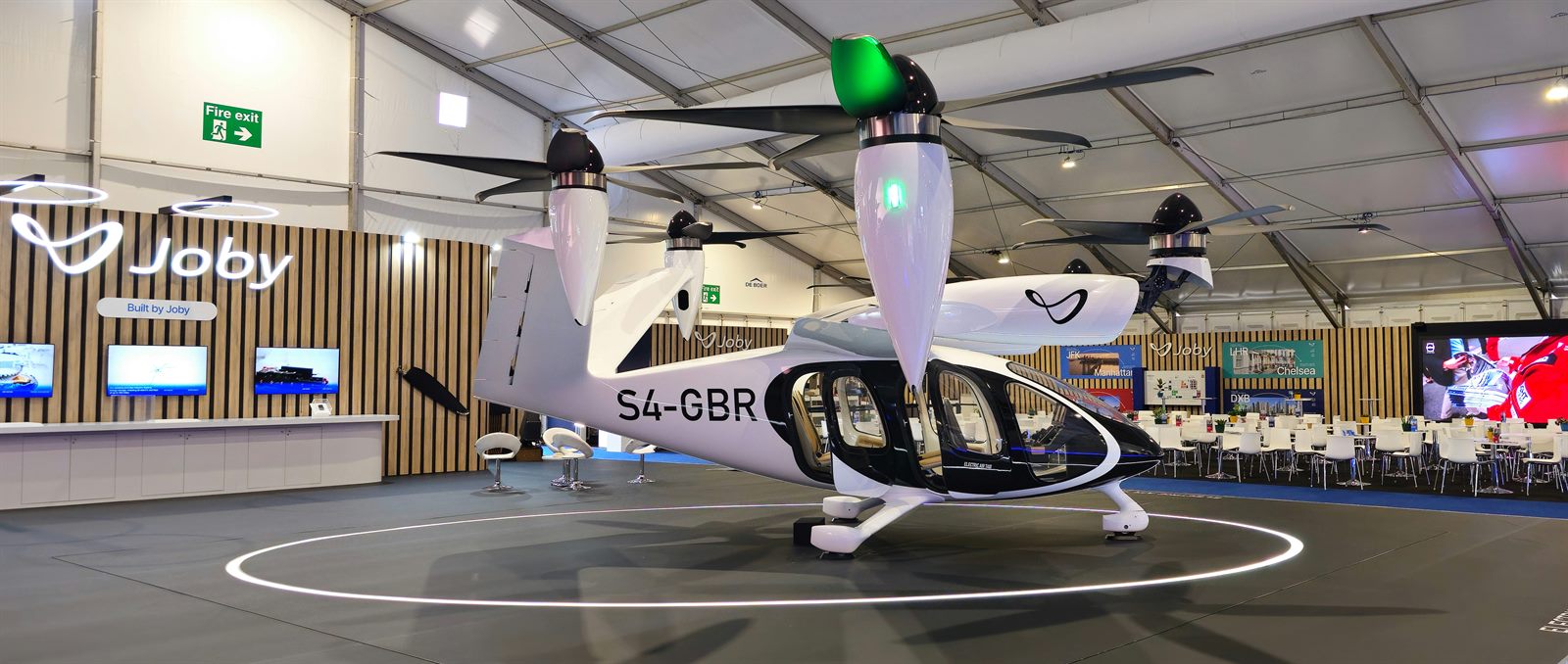 Passengers boarding an electric air taxi at an urban vertiport during early morning light