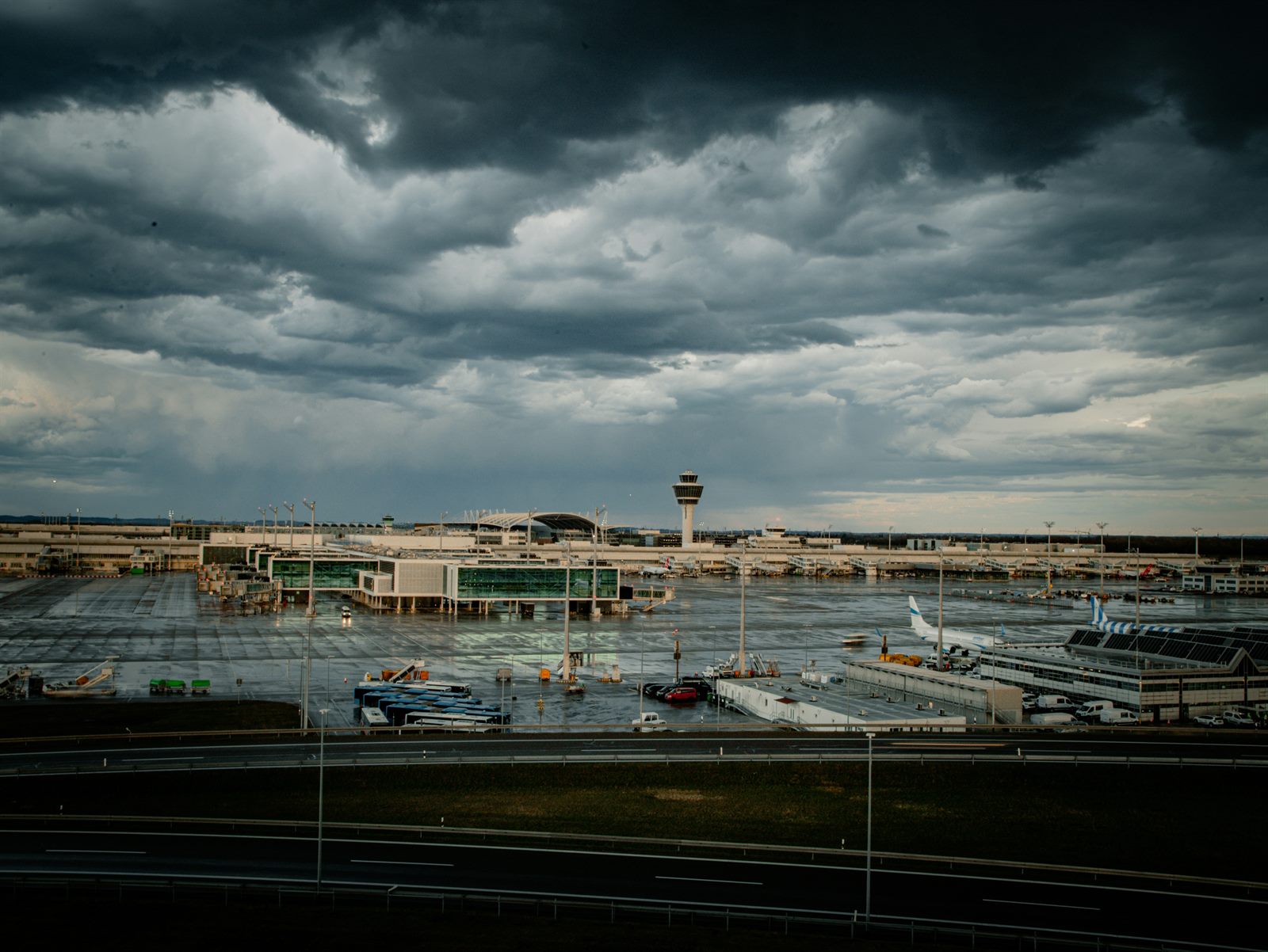 Aircraft releasing cloud seeding flares into storm clouds above an arid landscape