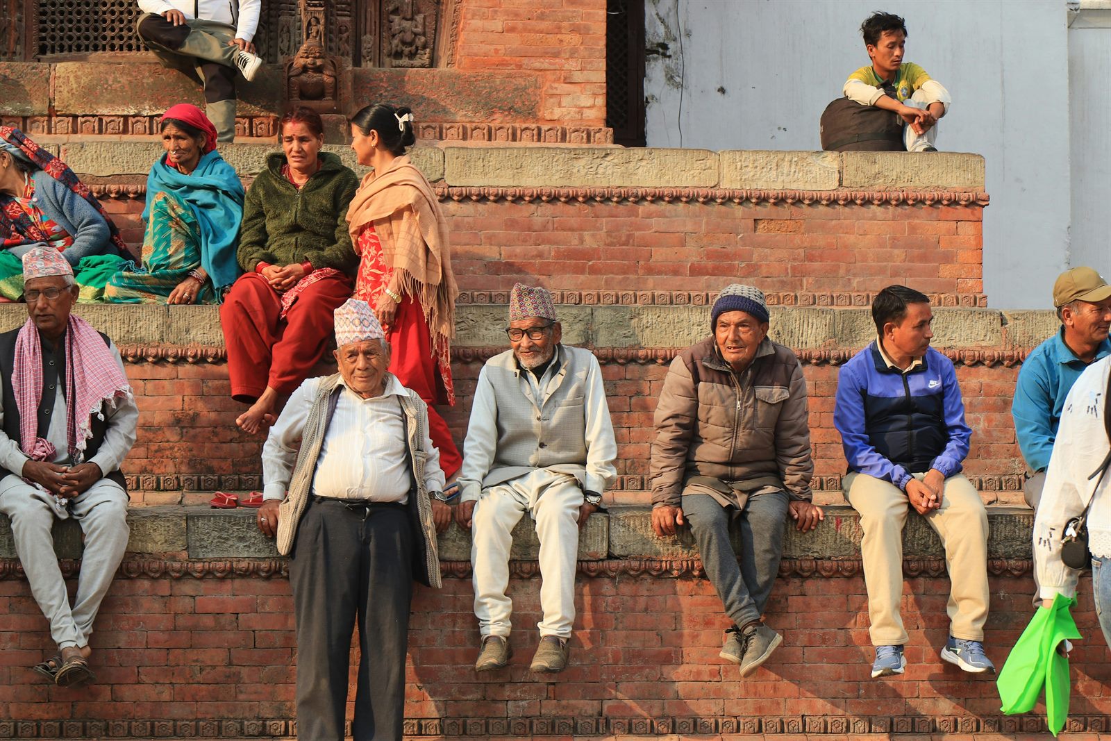A multigenerational crowd in a busy city street with noticeably more middle-aged and older faces than young children